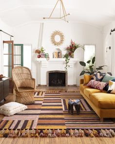 a living room filled with furniture and a fire place in the middle of the room