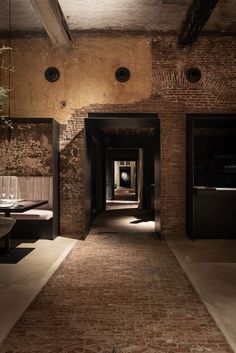 an image of a long hallway with brick walls and flooring on the bottom level