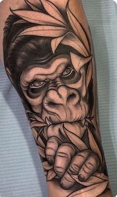 a man's arm with a tattoo on it and an image of a demon