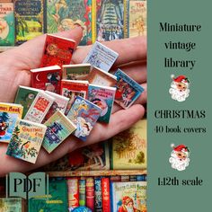 there is a hand that has many small christmas books in it and the words, miniature vintage library christmas 40 book covers