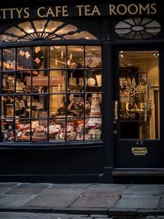 a store front with many different types of items on display in the window and outside