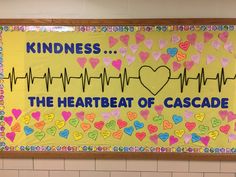 a bulletin board that says kindness the heartbeat of cascade with hearts on it