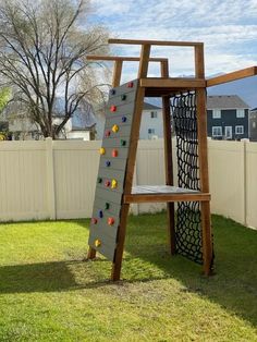 a wooden climbing frame in the grass