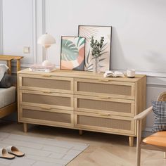 a bedroom with a bed, dresser and chair next to each other in front of a window