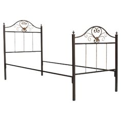 a metal bed frame with ornate designs on the headboard and foot board, against a white background