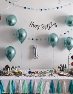 a birthday party with balloons, cake and decorations