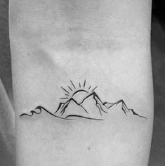 a black and white photo of a mountain tattoo