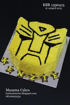 a cake with yellow frosting and black designs on it