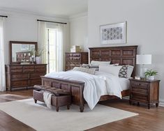 a bedroom scene with focus on the bed and dresser