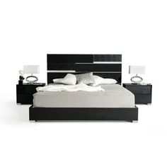 a black and white bed with two nightstands next to it on a white floor