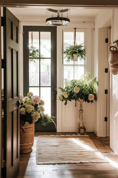 an entryway with potted plants on the side and a rug on the floor