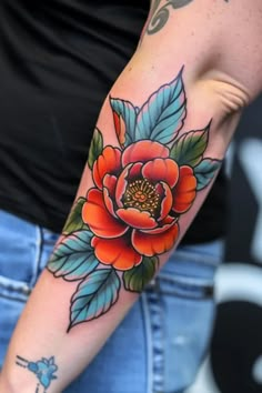 a woman with a flower tattoo on her arm