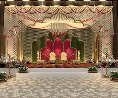 an elaborately decorated stage set up for a wedding ceremony with flowers and greenery