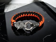 🐺 Embrace the spirit of the wolf with our Handmade Norse Celtic Wolf Head Bracelet! 🐺 This striking accessory blends rugged survival elements with stunning craftsmanship, making it perfect for adventurous souls and Viking enthusiasts alike. ️ Key Features: Celtic Wolf Design: A symbol of loyalty and courage, this intricate wolf head adds a fierce touch to your look. Durable Paracord: Ideal for outdoor activities, this bracelet is not just stylish--it's practical and ready for adventure! Stainless Steel Accents: Ensures durability and a sleek finish, keeping you looking sharp whether you're in the wild or at a gathering. ✨ Wear it on your next hike, camping trip, or just to showcase your love for Norse mythology. It's more than just a bracelet; it's a badge of honor for those who walk the Celtic Wolf, Paracord Survival Bracelet, Loyalty Symbol, Paracord Survival, Survival Bracelet, Wolf Design, Wolf Head, Paracord Bracelets, Braided Bracelets