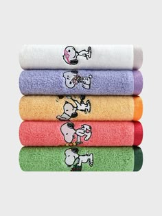 five towels with cartoon characters on them in different colors and sizes, all stacked together