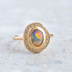 Our Pebble collection of raw, rough, beaten metals set with precious gems. Perfectly imperfect and all one of a kind. A Lightning Ridge black opal has been set into our Pompeii Ring with a surround of G/VS white brilliant cut diamonds. Black opal measures 8 x 6mm. Diamond halo weight 0.18ct. Top of ring measures 14 x 1 Sarah Gardner, Pebble Collection, Lightning Ridge Black Opal, Alexandrite Ring, Lightning Ridge, Pompeii, Precious Gems, Perfectly Imperfect, Boulder Opal