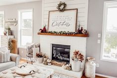 a living room filled with furniture and a fire place in front of a white brick fireplace