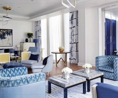 a living room filled with blue and white furniture