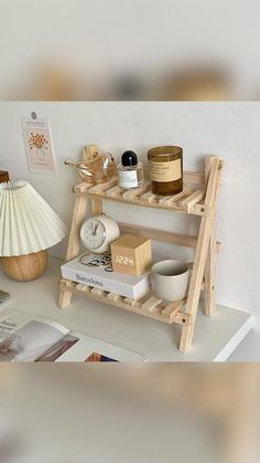 a shelf that has some items on top of it and a lamp next to it