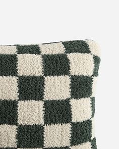 a black and white checkered pillow sitting on top of a table