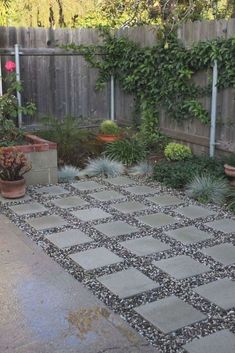 an outdoor patio with potted plants and gravel