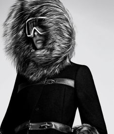 black and white photograph of a woman wearing ski goggles with fur on her head