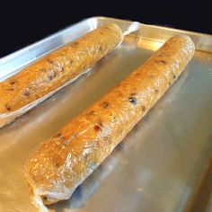 two long bread sticks sitting on top of a metal pan