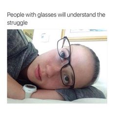 a woman wearing glasses laying on top of a bed with the caption when you try to lie on the couch