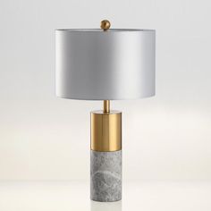 Add a modern edge to everyday decor with this chic column table lamp. Flaunting a smooth and stylish faux marble body accented by antiqued brass.  The classy aesthetic instantly dresses up ordinary living room decor. The drum hardback fabric shade beautifully diffuses the light into a soft, flattering glow.     Modern Fabric Shaded Table Lamp for Bedroom   Shade Material: Fabric  Base Color: Black/Gray/White  Number of Lights: 1-Light  Voltage: 220V-240V 110V-120V  Power Source: Plug In  Bulb Base: E26/E27  Bulb Included: No  Light Type: LED/Incandescent/Fluorescent    Fitting Environments  This lamp is a superb lighting solution that adds a soft touch of peace and positive energy to your living room, bedroom, foyer, dorm room, home office, or any room you place it in. It is also perfect d Bedside Marble Table, Night Lamp For Bedroom, Marble Table Lamp, Table Stand, Side Table Lamps, Stand Light, Fabric Lampshade, Gray Bedroom, Table Lamps For Bedroom