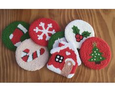 four christmas themed coasters on a wooden table