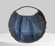 a denim purse sitting on top of a white table