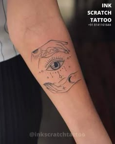 a woman's arm with a tattoo on it and an eye in the middle