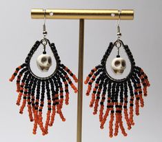 Halloween Seed Beaded Earrings Orange Black Fringe Dangle Earrings Handmade Unleash your adventurous spirit with these striking Seed Beaded Skull Earrings! Handcrafted to perfection, these uniquely designed earrings feature a mesmerizing combination of black and orange beads, perfect for your Halloween adventures. Made with lightweight materials, they won't weigh you down as you conquer the night. The sterling silver ear hooks with a 925 stamp add a touch of elegance to these 3-inch long earrings. Make a bold statement and embrace the thrill of the unknown with these handcrafted beauties! Halloween Hoop Earrings, Black Beaded Dangle Earrings For Halloween, Black Dangle Beaded Earrings For Halloween, Ghost Beaded Earrings, Beginner Seed Bead Patterns, Halloween Earrings Diy, Halloween Beaded Earrings, Halloween Earrings Beaded, Halloween Beaded Jewelry