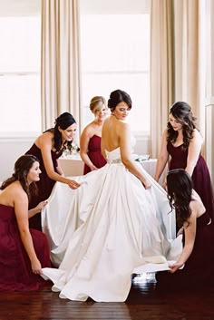 bridesmaids helping the bride get ready for her big day in red and white