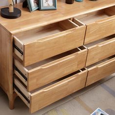 a wooden dresser with drawers and pictures on it