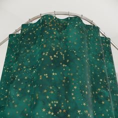 a green curtain with gold stars on it