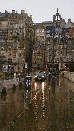 cars are parked on the street in the rain