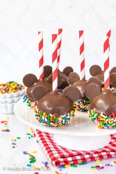 mickey mouse cupcakes with chocolate frosting and sprinkles on a plate