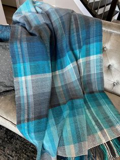 Our Nevermind handwoven blanket is both lightweight and soft, making it perfect for cool evenings outdoors or cozied up in your favorite chair. Featuring a unique plaid in vibrant blues, turquoises, classic greys, whites and an ombre fringe finish, this 100% acrylic blanket is the perfect accent throw for your home. Measures approximately 40" x 71" without fringe. Fringe is approximately 4" long. Hand wash or machine wash delicate, tumble dry low. Handwoven Blanket, Rigid Heddle Loom, Floor Loom, Hand Woven Blanket, Heddle Loom, Card Pattern, Purse Gift, Wool Shawl, Loom Weaving