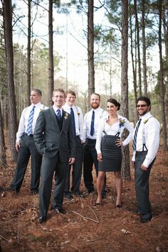 a group of people standing next to each other in the woods