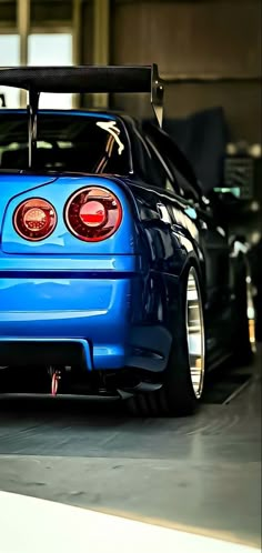 the rear end of a blue sports car