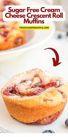 a close up of a muffin on a plate with blueberries in the background