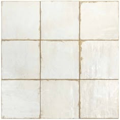 a white tile wall with several squares in it