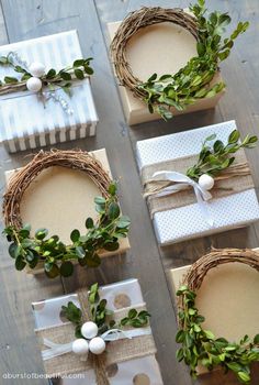 four wrapped presents with wreaths on them