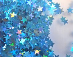 many blue and green stars are flying in the air