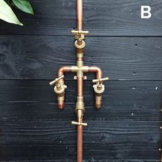 an old fashioned water faucet is shown on the side of a wooden wall