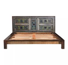 a wooden bed frame with intricate designs on the top and bottom panel, made from wood