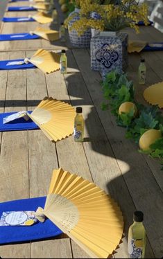 the table is set up with blue and yellow paper fans