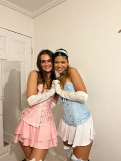 two young women dressed in costumes posing for the camera with their arms around each other