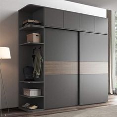 a room with a large gray cabinet and some lights on the side walk in closet